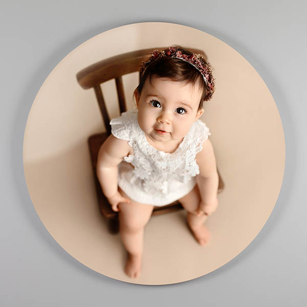 Custom photo wall art of an acrylic photo print of a sleeping baby in a blue chair