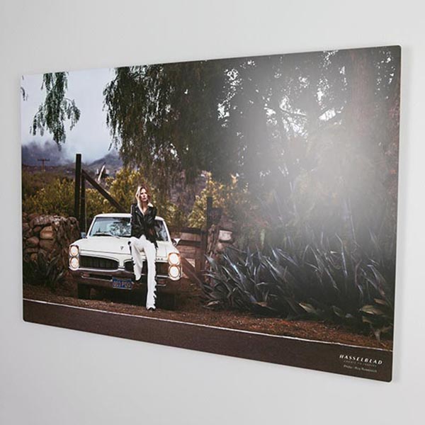 Bespoke photo display product of an aluminium photo print of a baby smiling in a studio shoot
